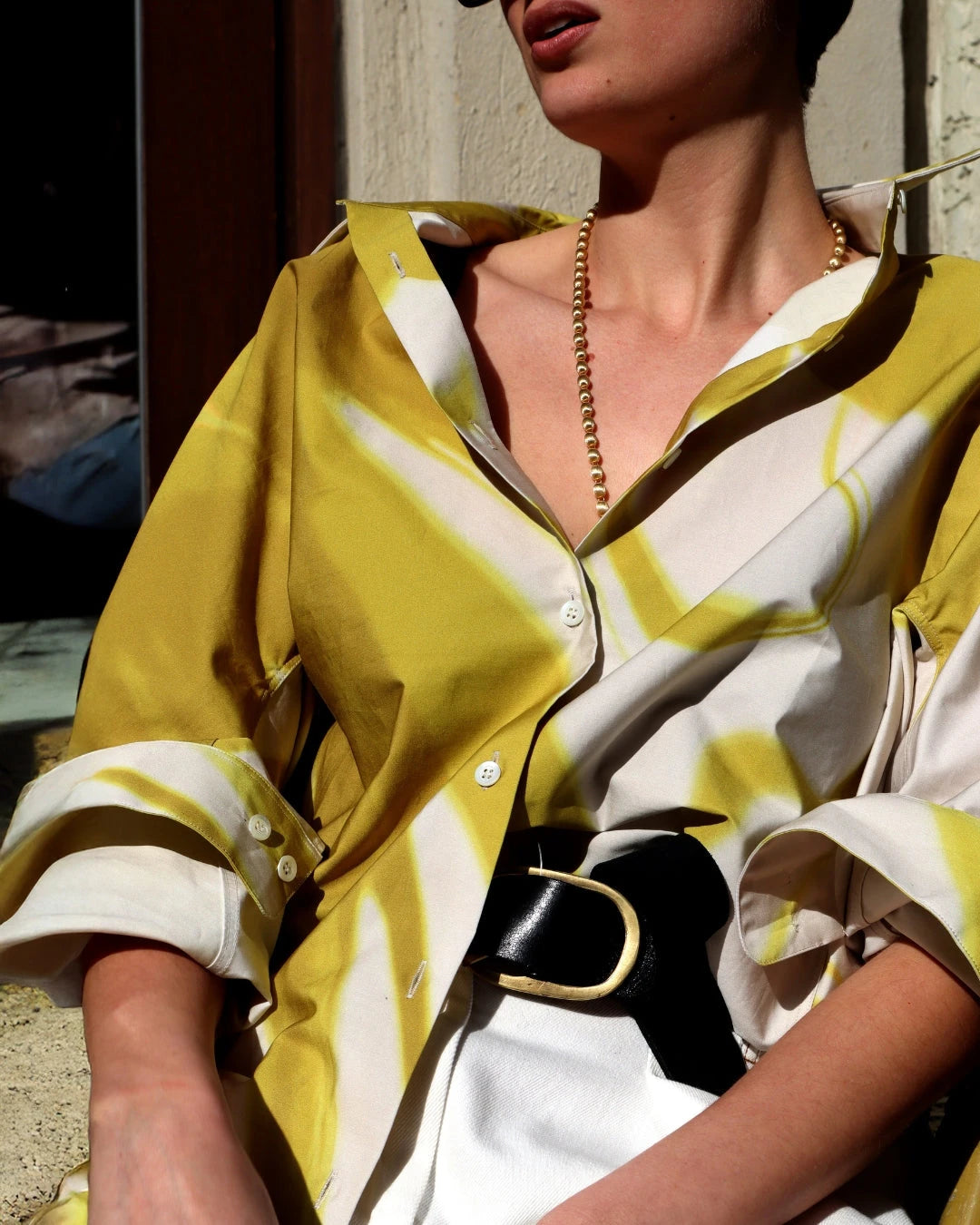 DRIES VAN NOTEN SS25 COLLECTION IMAGE SHOWING CLOSE UP OF MODEL WEARING PRINTED BUTTON UP SHIRT