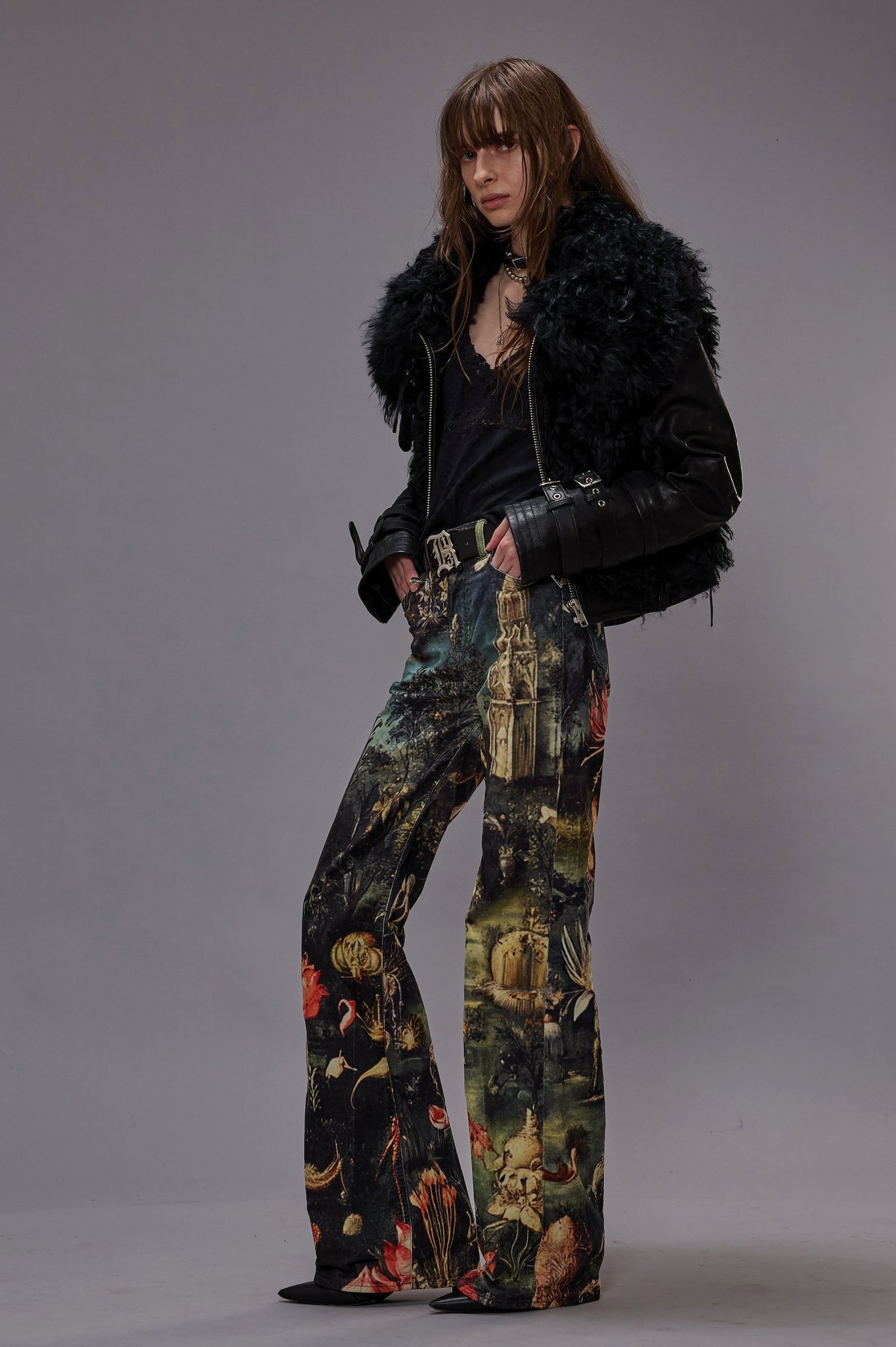 R13 FW25 COLLECTION IMAGE SHOWING MODEL WEARING BLACK FURRY JACKET AND PRINTED WIDE LEG JEANS