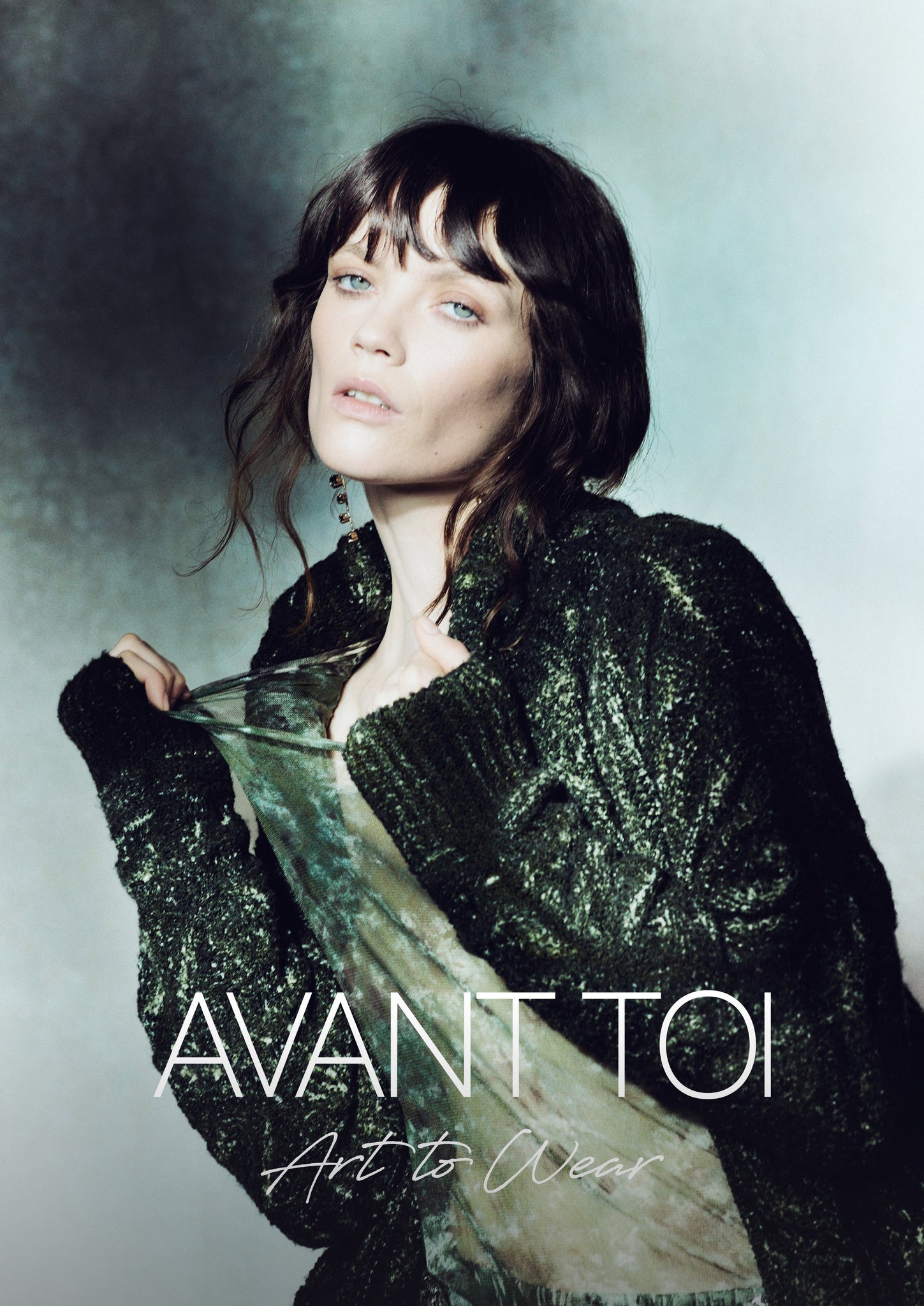 AVANT TOI FW25 COLLECTION IMAGE SHOWING MODEL WEARING GREEN SWEATER WITH THE AVANT TOI ART TO WEAR LOGO ON TOP