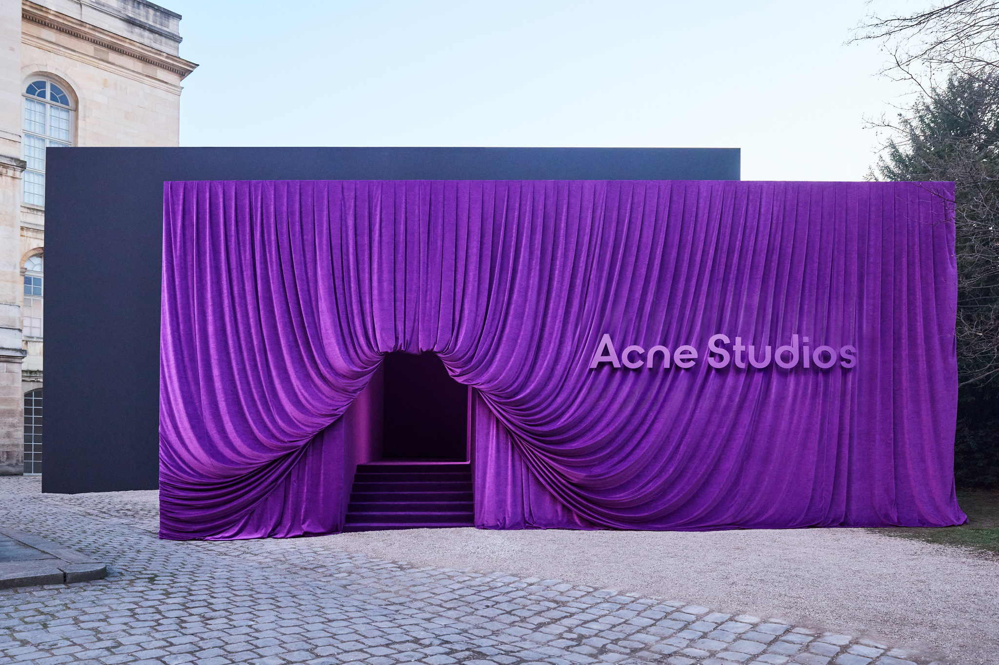 ACNE STUDIOS LOCATION FRONT OUTSIDE COVERED IN DRAPED PURPLE FABRIC