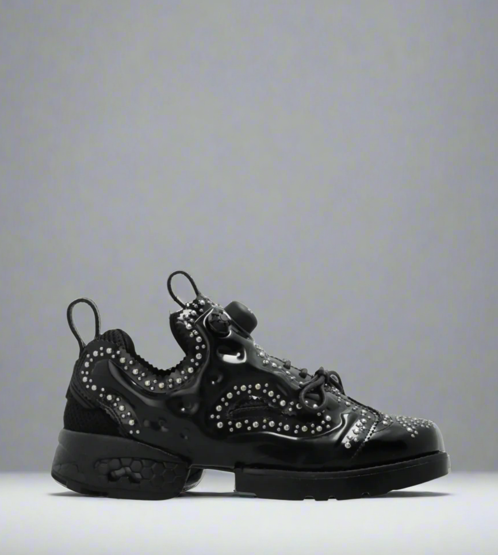 SIDE VIEW OF NOIR KEI NINOMIYA X REEBOK SNEAKER