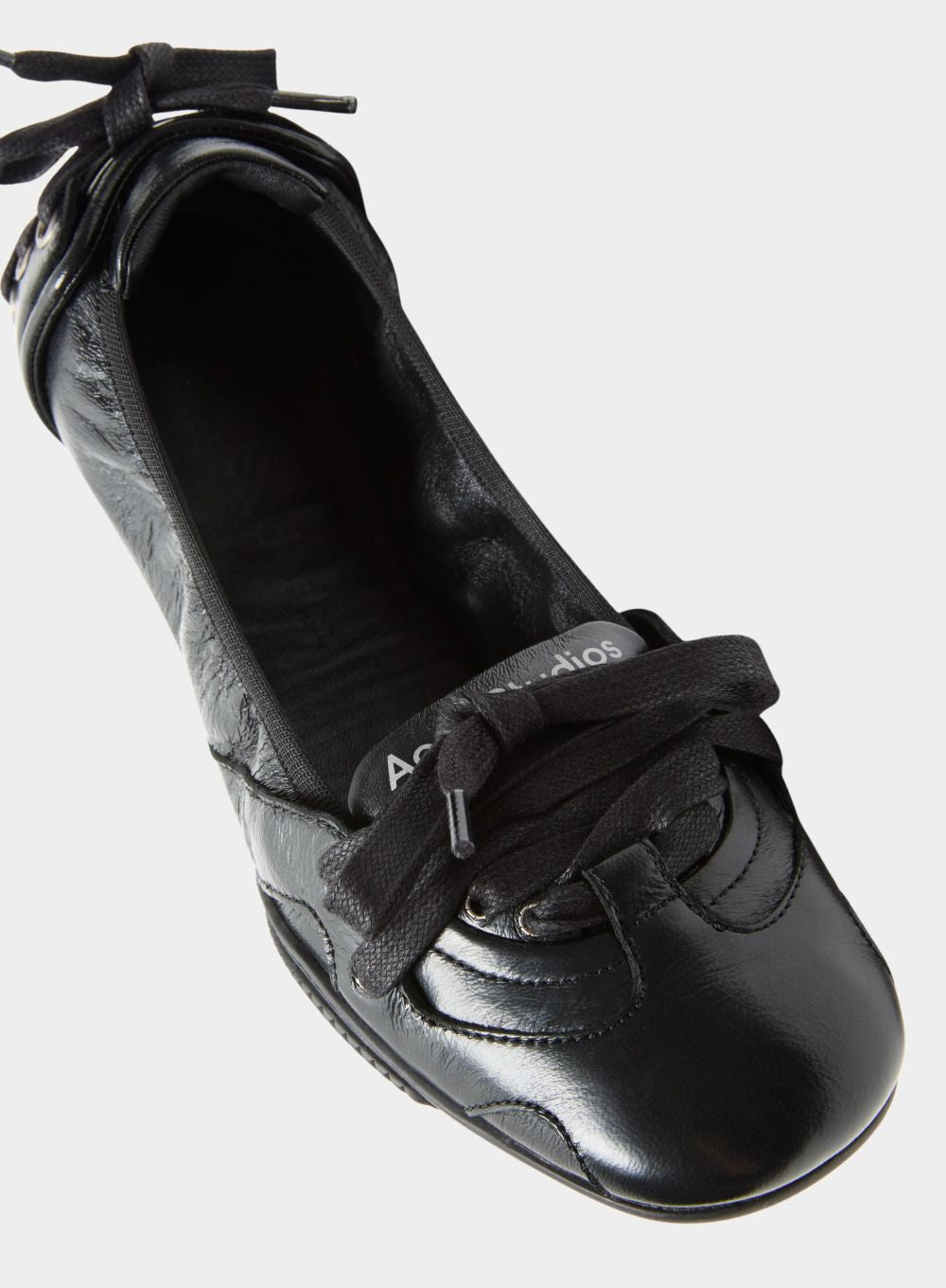 Black shoe with a bow on a white background