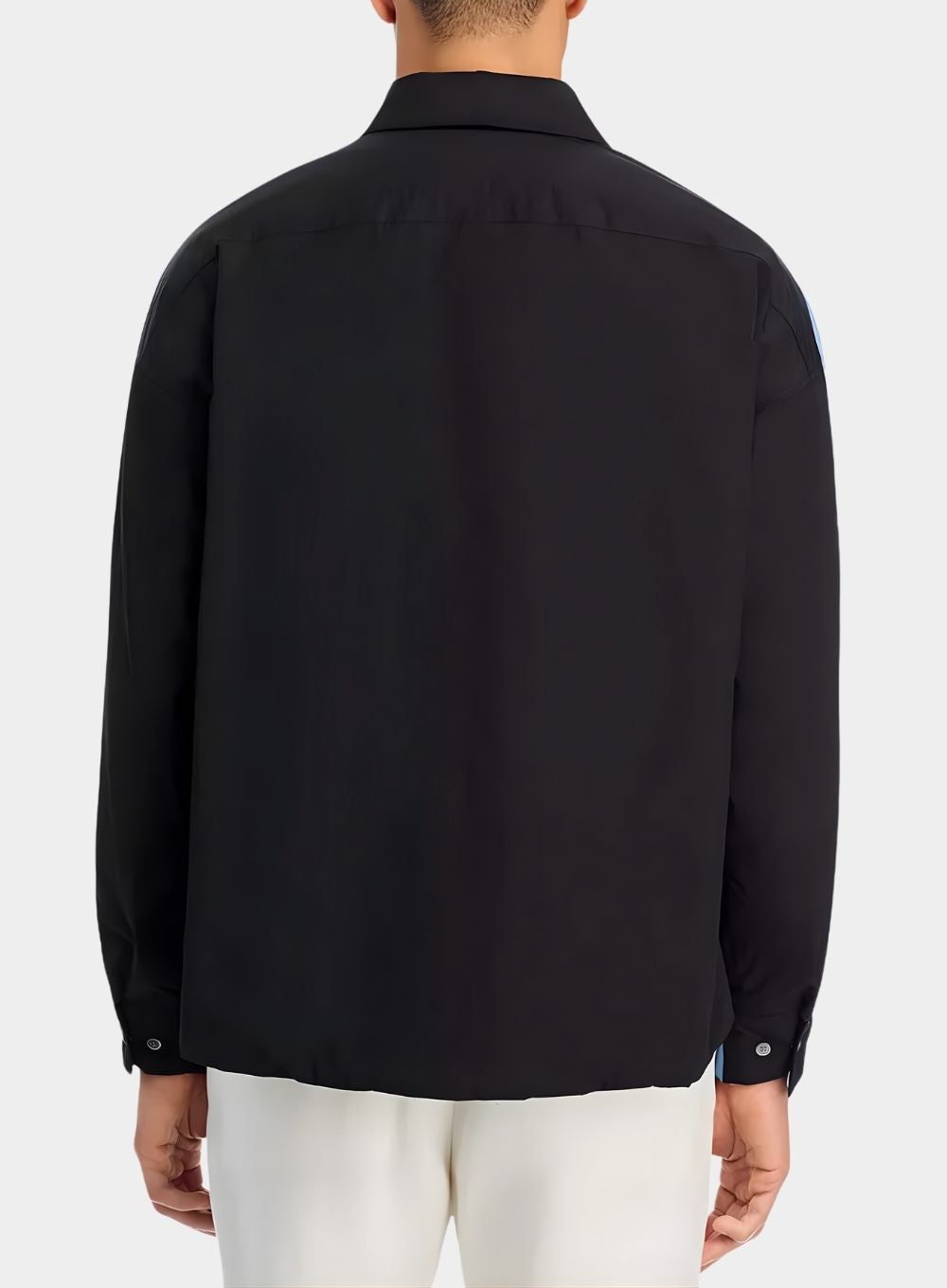 Black shirt worn by a person on a white background