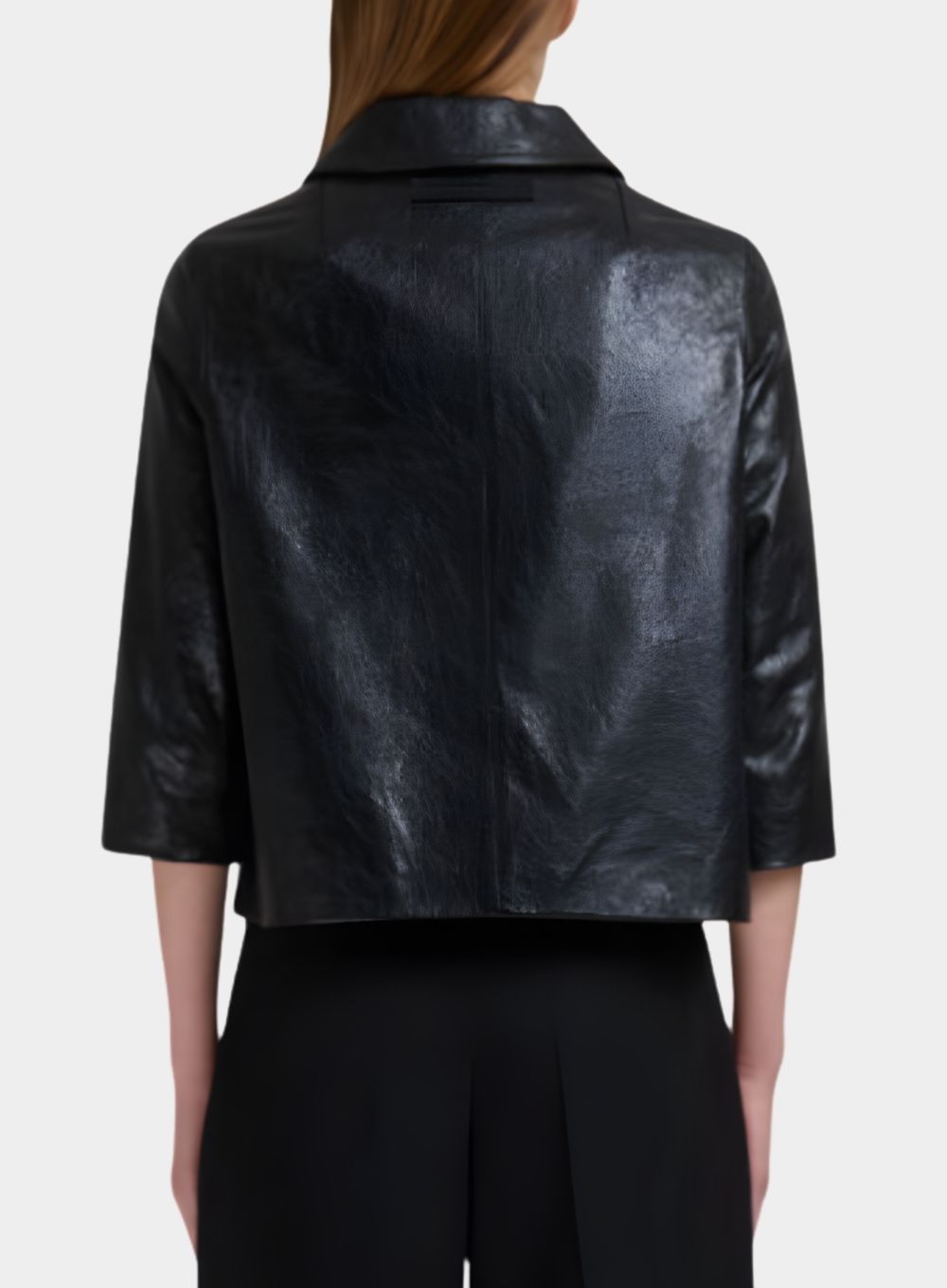 Black leather jacket worn by a person on a white background