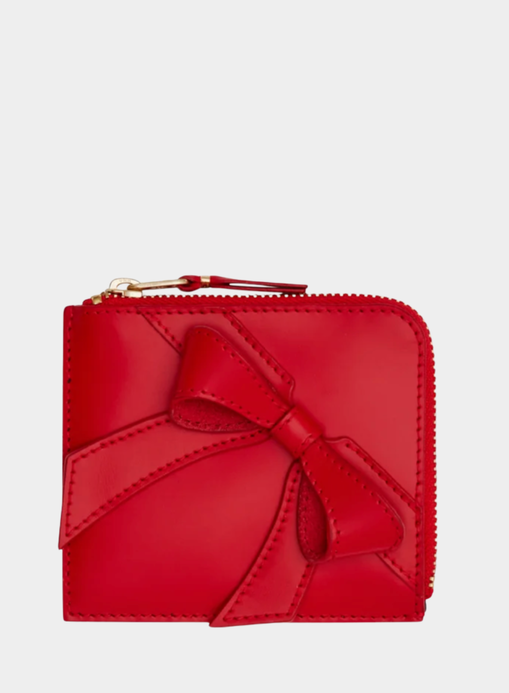 Red wallet with a bow on a light gray background
