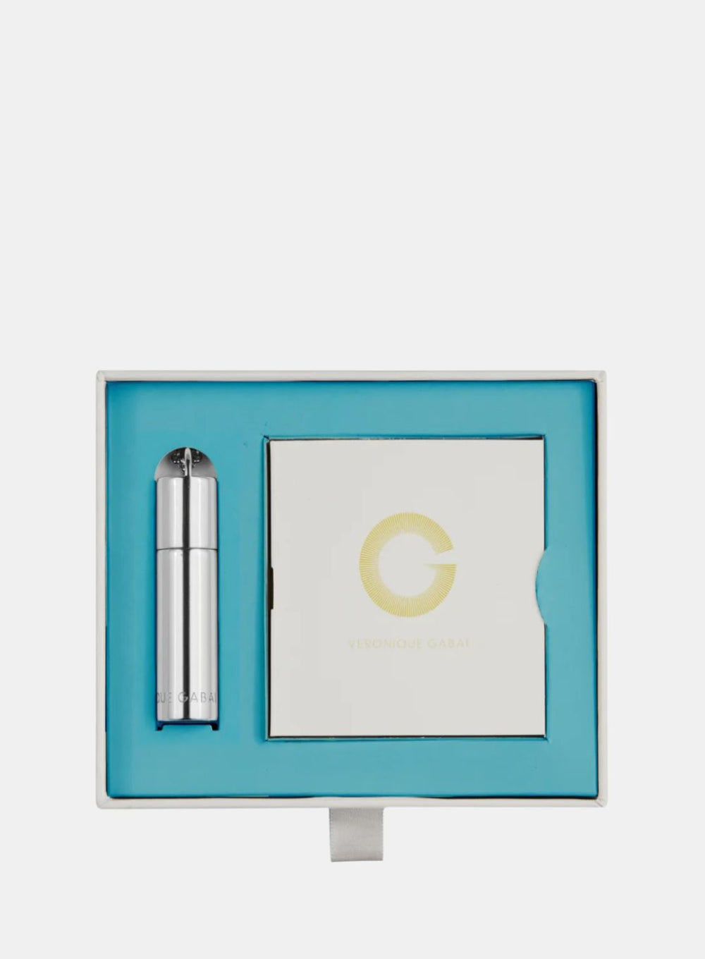 Skincare product set with a blue box, silver tube, and white square on a light gray background