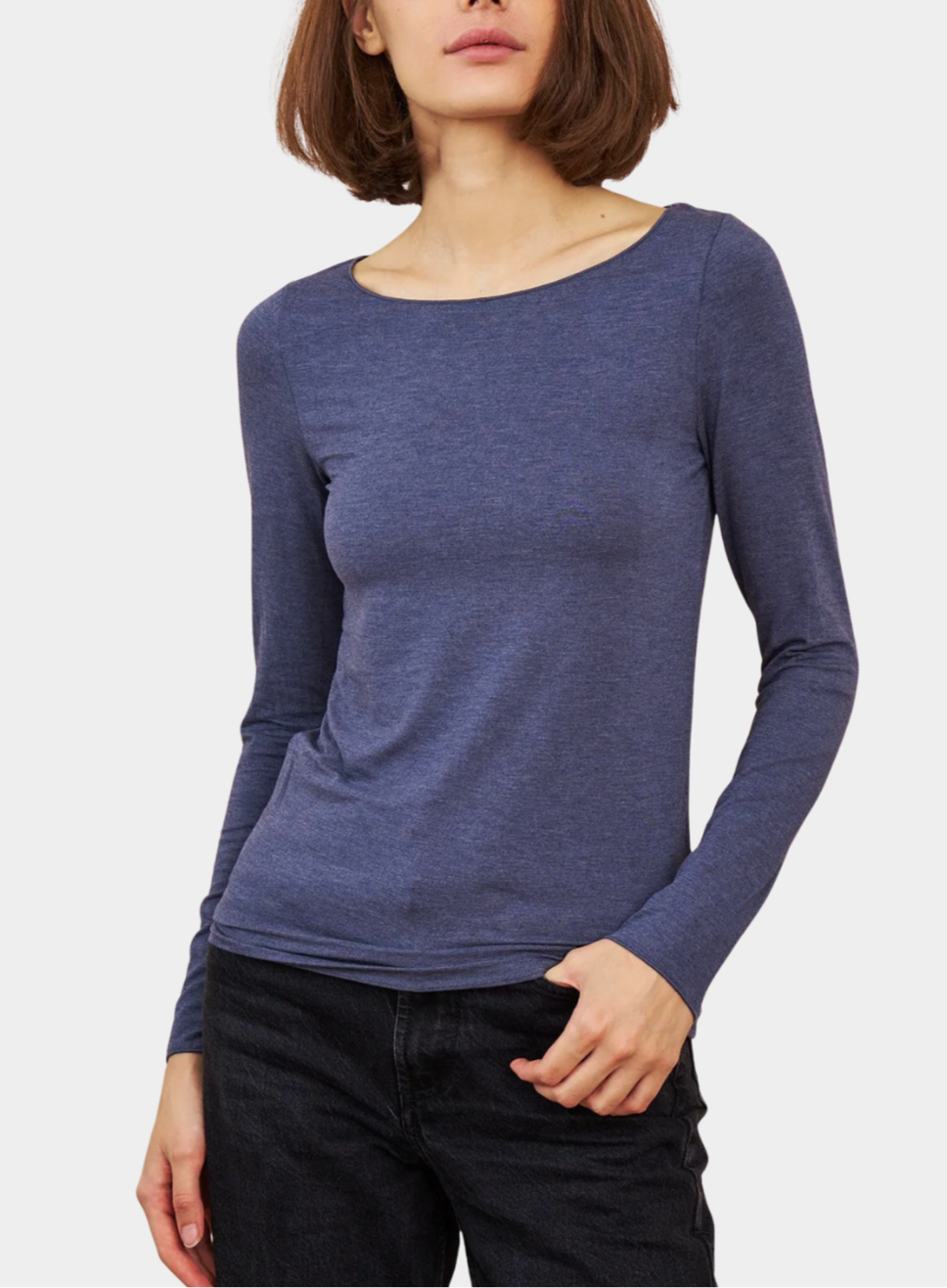 Woman wearing a blue long-sleeve top on a white background