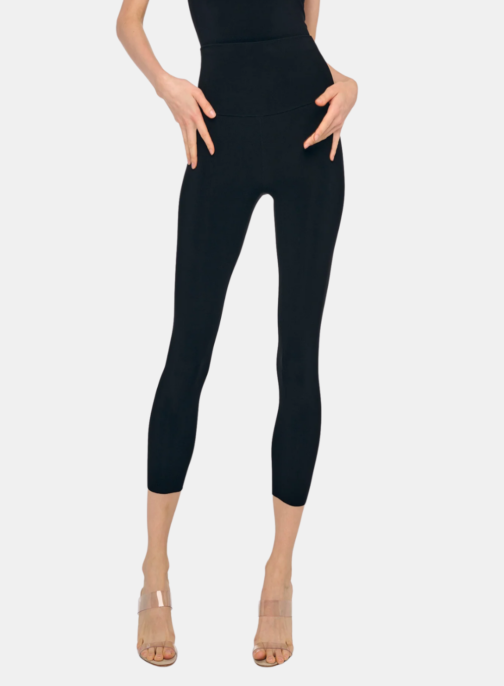 Black leggings worn by a person on a white background