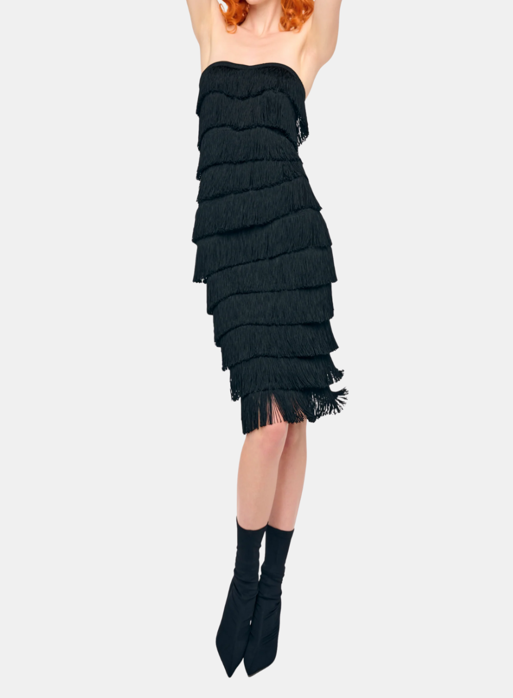 Black ruffled skirt worn by a person on a white background
