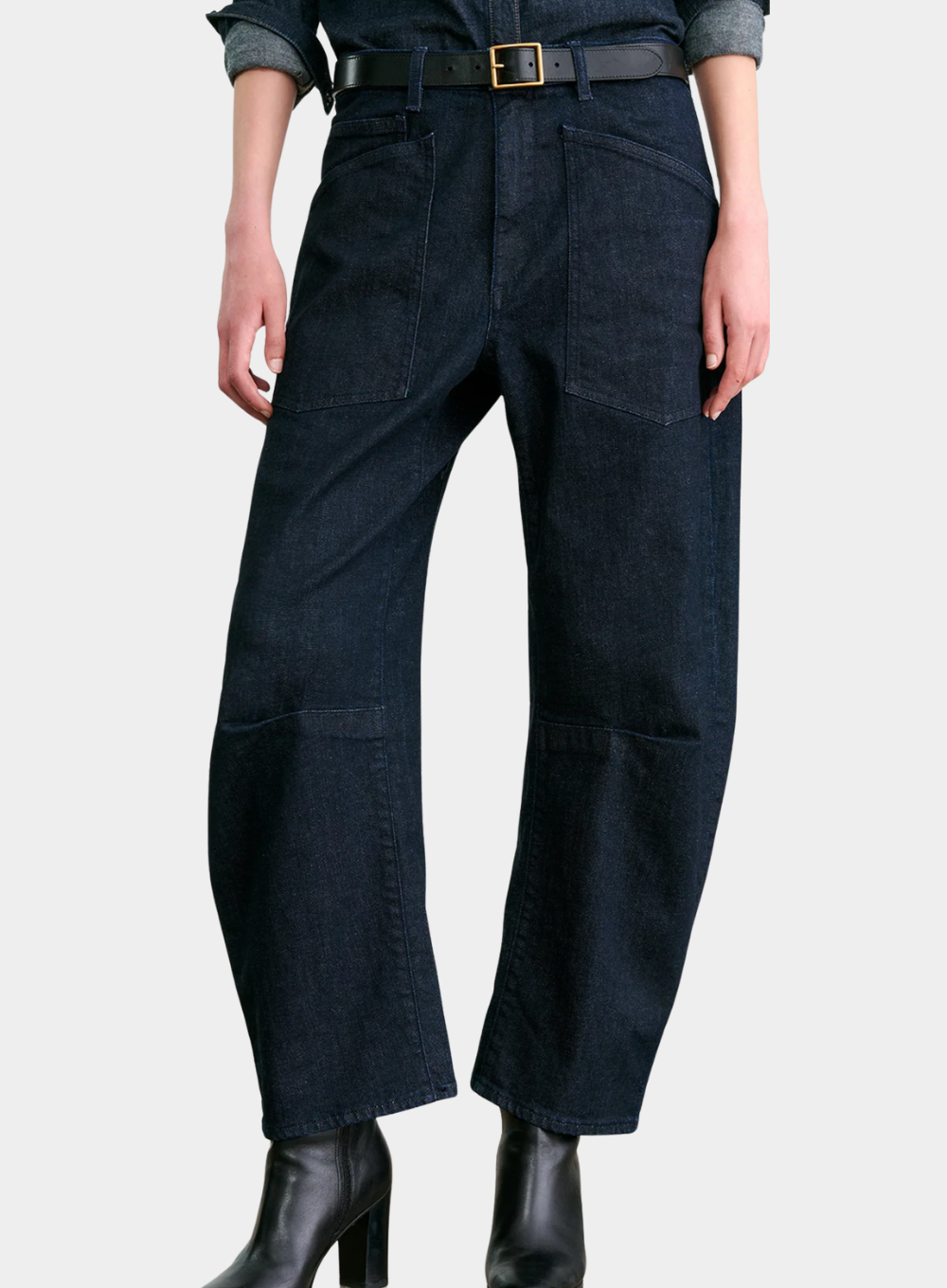 Dark blue coveralls worn by a person on a light gray background