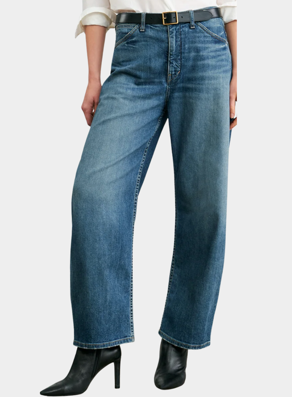 Person wearing blue jeans with a white background