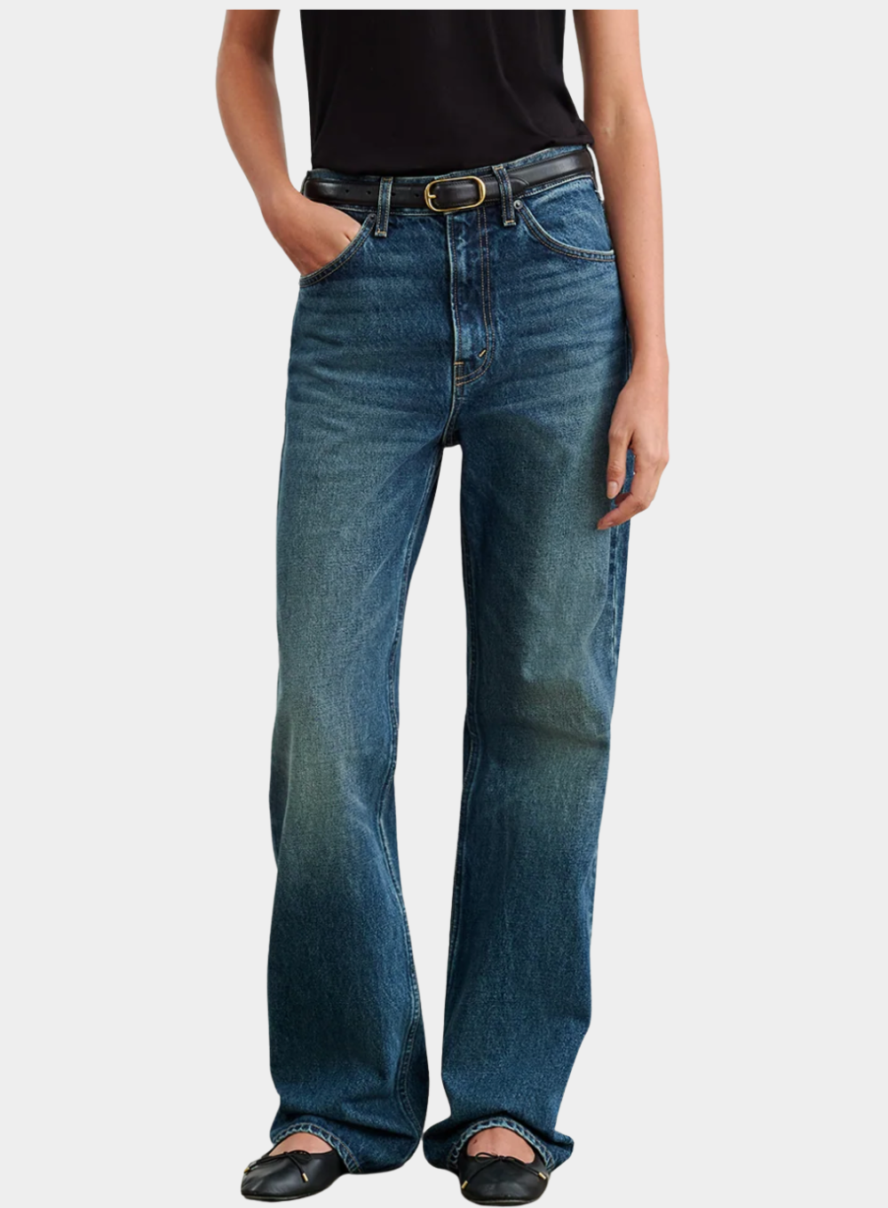 Person wearing blue jeans on a white background