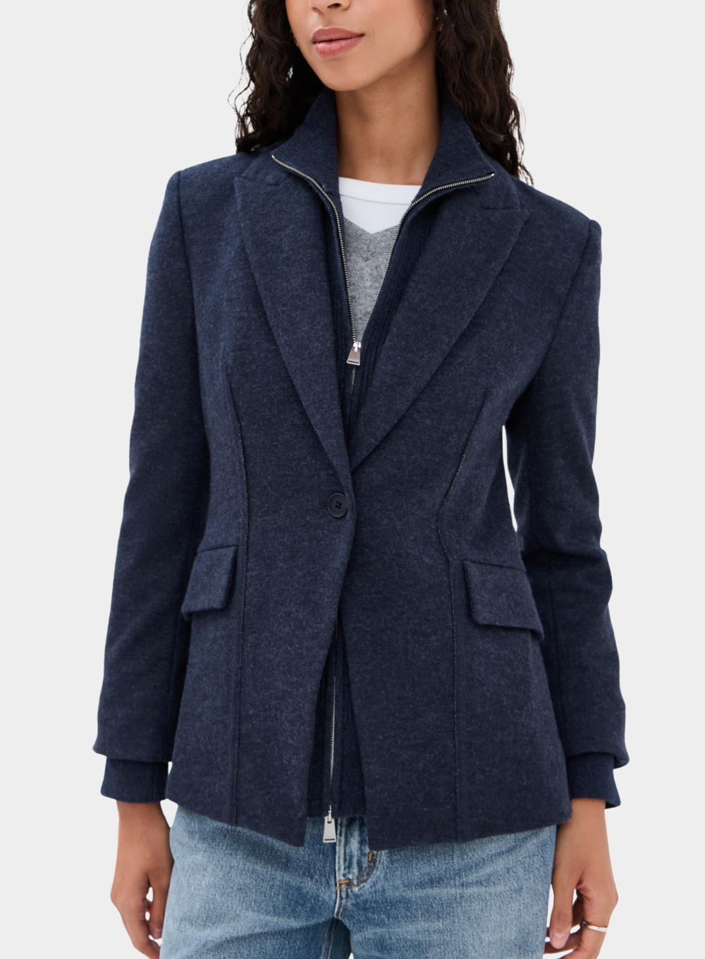Navy blazer worn by a person on a white background