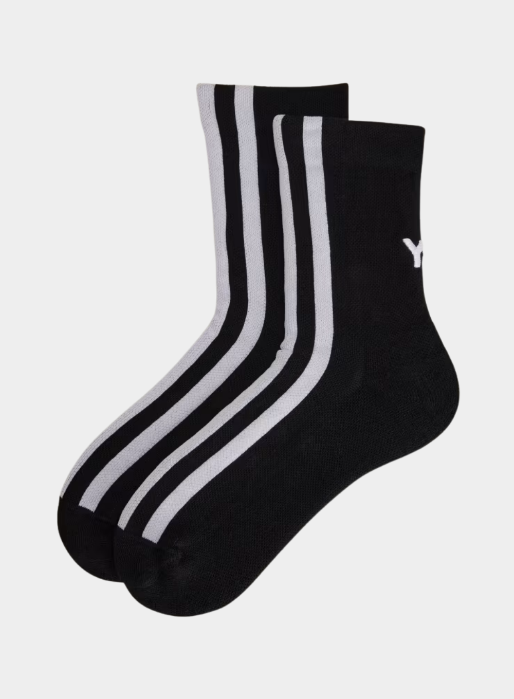 Black socks with white stripes on a light gray background