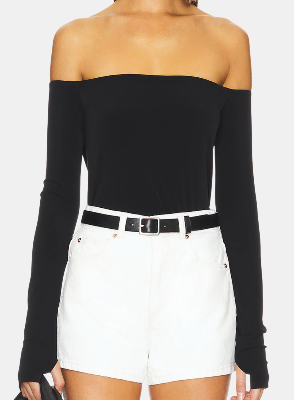 Black off-shoulder top and white shorts on a plain background