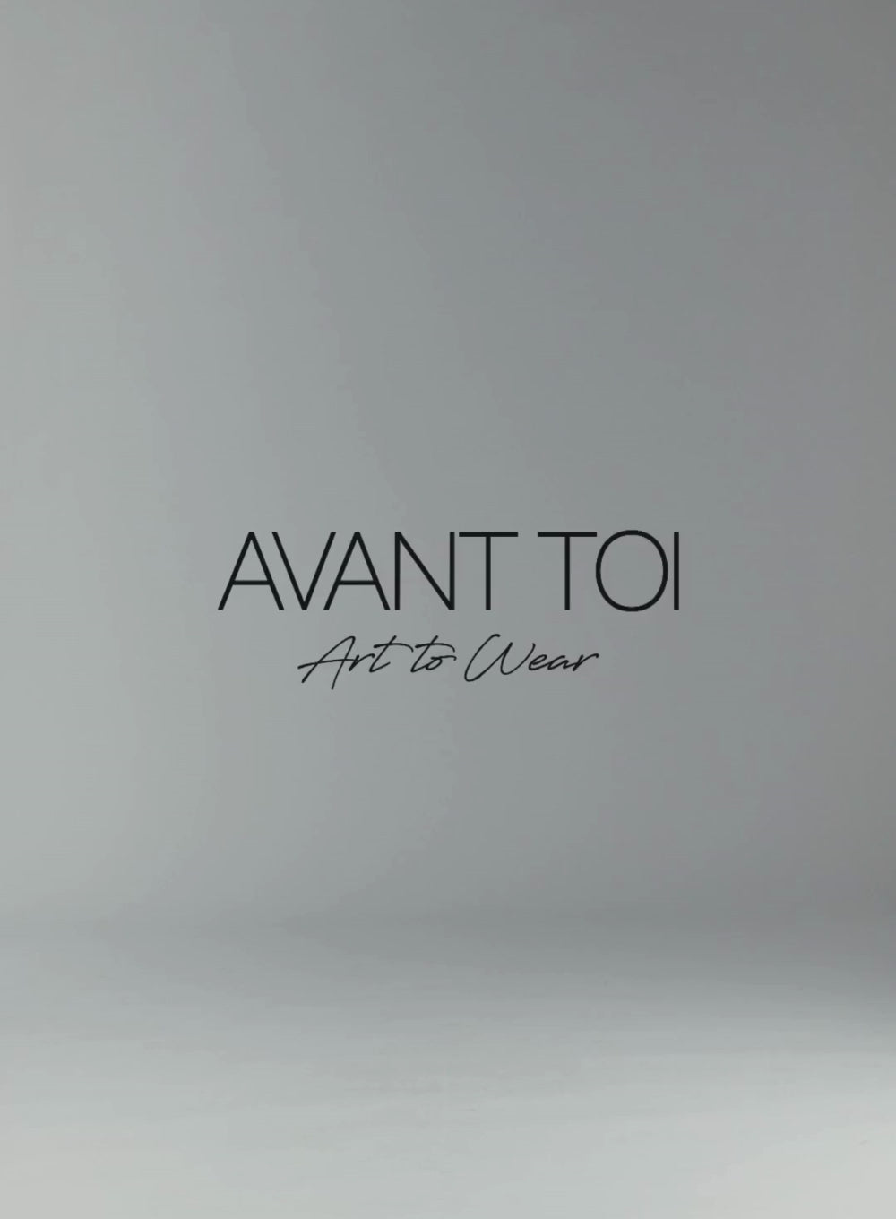 Video of model walking on-screen wearing beige houndstooth rever jacket and black pants, Avant Toi Art to Wear logo text in background